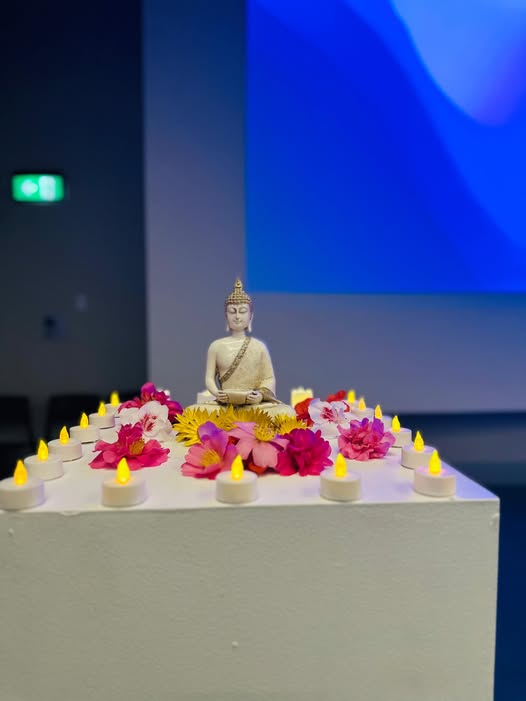 Buddha statue with flowers and candles at the Vesak and Poson Celebration 2026